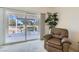 Comfortable chair facing sliding doors to the patio and desert view, with a plant on the side at 7921 Fantail Dr, North Las Vegas, NV 89084