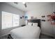 Well-lit bedroom featuring a cozy bed, window with blinds, and minimalist decor at 810 Roaring Falls Ave, Henderson, NV 89052