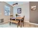 Inviting dining area featuring a wooden table set, bench seating, and modern lighting fixture at 8240 Corset Creek St, Las Vegas, NV 89131