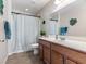 Bathroom featuring a shower-tub combo with wood cabinets, and tile floors at 8248 Southern Cross Ave, Las Vegas, NV 89131