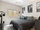 Cozy bedroom with a large window, ceiling fan, modern decor, and ample natural light at 8248 Southern Cross Ave, Las Vegas, NV 89131