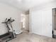 Spacious bedroom with a closet, carpet floors, and a treadmill at 8248 Southern Cross Ave, Las Vegas, NV 89131