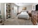 Bright bedroom with a neutral color scheme, decorative dresser, and built-in bookshelf at 8248 Southern Cross Ave, Las Vegas, NV 89131