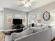 Comfortable living room with stylish furniture, large windows, and a modern ceiling fan, perfect for relaxation and entertainment at 8248 Southern Cross Ave, Las Vegas, NV 89131