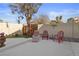 Charming backyard patio with comfortable lounge chairs, a decorative wall, and a tranquil atmosphere at 8432 Squaw Valley Ave, Las Vegas, NV 89128