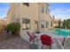 Backyard boasts a sparkling pool, patio, and lush landscaping for ultimate outdoor enjoyment at 8432 Squaw Valley Ave, Las Vegas, NV 89128