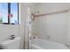 Bright bathroom features a shower-tub combo with a pink tiled wall and a black frame window at 8432 Squaw Valley Ave, Las Vegas, NV 89128