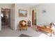 Well-lit bedroom with an open doorway to the bathroom and hallway, adorned with cozy furniture at 8432 Squaw Valley Ave, Las Vegas, NV 89128