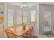 Sun-filled breakfast nook with large windows, a ceiling fan, and seating for four at 8432 Squaw Valley Ave, Las Vegas, NV 89128