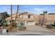 Charming two-story home featuring a tile roof, desert landscaping, and a spacious two-car garage at 8432 Squaw Valley Ave, Las Vegas, NV 89128