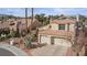 Charming two-story home featuring a tile roof, desert landscaping, and a spacious two-car garage at 8432 Squaw Valley Ave, Las Vegas, NV 89128