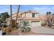 Charming two-story home featuring a tile roof, desert landscaping, and a spacious two-car garage at 8432 Squaw Valley Ave, Las Vegas, NV 89128