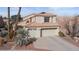 Charming two-story home featuring a tile roof, desert landscaping, and a spacious two-car garage at 8432 Squaw Valley Ave, Las Vegas, NV 89128