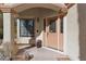 Covered entryway featuring a wooden front door with glass detailing at 8432 Squaw Valley Ave, Las Vegas, NV 89128