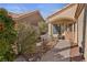 Inviting entrance with a well-manicured garden and covered front porch at 8432 Squaw Valley Ave, Las Vegas, NV 89128