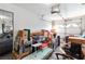 Cluttered garage interior with car, boxes, and storage items, automatic opener, and open side area at 8432 Squaw Valley Ave, Las Vegas, NV 89128