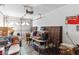 Cluttered garage interior with white door, automatic opener, storage boxes, and old furniture at 8432 Squaw Valley Ave, Las Vegas, NV 89128