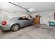 Well-lit garage interior with ample storage space, side entrance door, and car inside at 8432 Squaw Valley Ave, Las Vegas, NV 89128