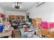 Cluttered garage interior filled with tools, boxes, and storage items, automatic opener, and work area at 8432 Squaw Valley Ave, Las Vegas, NV 89128