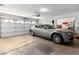 Spacious garage with white door and automatic opener, perfect for parking and storage with car inside at 8432 Squaw Valley Ave, Las Vegas, NV 89128