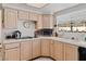 Bright kitchen features tiled countertops, light wood cabinets, and an electric stove cooktop at 8432 Squaw Valley Ave, Las Vegas, NV 89128