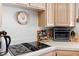 Kitchen featuring light wooden cabinets, a Ninja Foodi oven, and electric stove cooktop at 8432 Squaw Valley Ave, Las Vegas, NV 89128