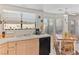 Kitchen with a window over the sink and an adjacent dining area with a light fixture at 8432 Squaw Valley Ave, Las Vegas, NV 89128