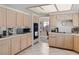 Kitchen with ample light wood cabinets, tile floors, and stainless steel microwave at 8432 Squaw Valley Ave, Las Vegas, NV 89128