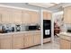 Kitchen with ample light wood cabinets, tile floors, and stainless steel microwave at 8432 Squaw Valley Ave, Las Vegas, NV 89128