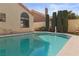 The pool features a hot tub, ladder, and tall privacy hedges on the property line at 8432 Squaw Valley Ave, Las Vegas, NV 89128