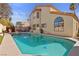 The pool has a hot tub, ladder, and a patio with chairs and a table for lounging at 8432 Squaw Valley Ave, Las Vegas, NV 89128