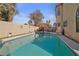 The pool has a hot tub, ladder, and a patio with chairs and a table for lounging at 8432 Squaw Valley Ave, Las Vegas, NV 89128