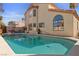The pool has a hot tub, ladder, and a patio with chairs and a table for lounging at 8432 Squaw Valley Ave, Las Vegas, NV 89128
