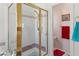 Shower with gold frame, decorative tile, and a large window bringing in natural light at 8432 Squaw Valley Ave, Las Vegas, NV 89128