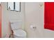 Close-up of a standard white toilet with a red towel hanging on the wall at 8432 Squaw Valley Ave, Las Vegas, NV 89128
