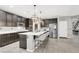 Modern kitchen featuring stainless steel appliances, a large island, and stylish pendant lighting at 8639 Tortoise Canyon Ct, Las Vegas, NV 89148