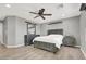 Spacious main bedroom featuring a ceiling fan, wood floors, and updated furniture at 8639 Tortoise Canyon Ct, Las Vegas, NV 89148