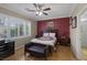 Comfortable bedroom featuring hardwood floors, a large window, and ensuite bath access at 8645 Deering Bay Dr, Las Vegas, NV 89131