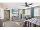 Bright bedroom featuring a ceiling fan, dresser, and barn door at 8677 Nichols Ave, Las Vegas, NV 89148