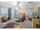 Bedroom with plush carpet, upholstered headboard, and windows at 8677 Nichols Ave, Las Vegas, NV 89148