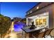 Inviting patio area with a dining set overlooking the pool and spa, seamlessly connecting indoor and outdoor living at 8677 Nichols Ave, Las Vegas, NV 89148