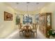 Elegant dining room with a bay window, decorative chandelier, and a classic china cabinet at 8961 Rivers Edge Dr, Las Vegas, NV 89117