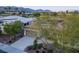 Single-story home with solar panels, lush landscaping, and a private driveway, blending sustainability with style at 10534 Mandarino Ave, Las Vegas, NV 89135