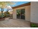 Outdoor living with a tiled back patio area, desert landscaping, and mature trees at 10534 Mandarino Ave, Las Vegas, NV 89135