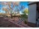 Well-maintained backyard featuring mature trees, brick lined garden area, and a small water feature at 10534 Mandarino Ave, Las Vegas, NV 89135