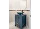 Elegant powder room with a vessel sink and a vanity with gold hardware at 10534 Mandarino Ave, Las Vegas, NV 89135