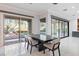 Contemporary dining room with a modern table set and sliding glass door to the outside at 10534 Mandarino Ave, Las Vegas, NV 89135