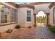 Home featuring a secure gated front entrance leading to a covered patio with refined architectural details at 10534 Mandarino Ave, Las Vegas, NV 89135