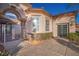 Home featuring a secure gated front entrance leading to a covered patio with refined architectural details at 10534 Mandarino Ave, Las Vegas, NV 89135