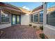 Welcoming front porch featuring decorative brickwork, double doors, and multiple windows for natural light at 10534 Mandarino Ave, Las Vegas, NV 89135